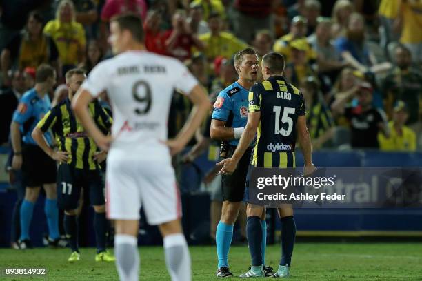 Referee Alex King talks to Alan Baro about a decision during the round 11 A-League match between the Central Coast and the Western Sydney Wanderers...