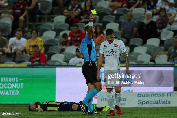 Referee Alex King issues a yellow card to Josh Risdon of the Wanderers during the round 11 A-League match between the Central Coast and the Western...