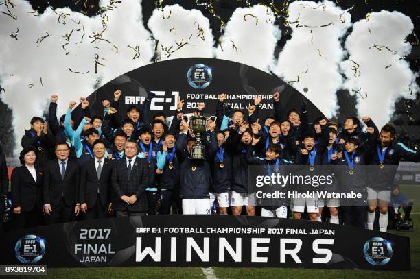 Captain Jang Hyunsoo of South Korea lifts the trophy as they celebrate the East Asian Champions at the award ceremony following their 4-1 victory in...