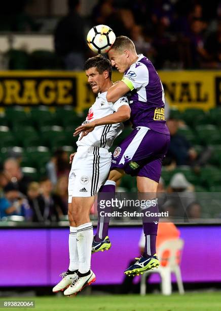 Shane Lowry of the Glory contests a header ball against Andrija Kaludjerovic of the Phoenix during the round 11 A-League match between the Perth...