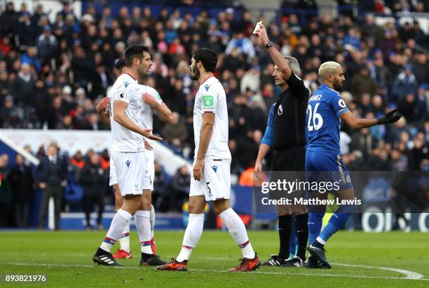 Match referee Martin Atkinson shows Scott Dann of Crystal Palace after he tackels Riyad Mahrez of Leicester City during the Premier League match...