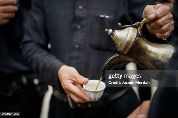 having traditional arabian coffee with friends - doha street stock pictures, royalty-free photos & images