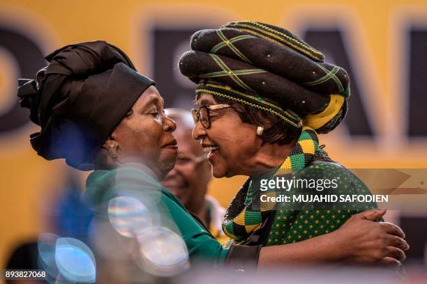 The former wife of the late South African President Nelson Mandela, anti-apartheid campaigner Winnie Mandela , greets the candidate for the African...