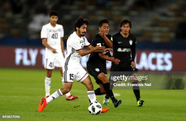 Khalfan Alrezzi of Al Jazira is challenged by Erick Sanchez of CF Pachuca during the FIFA Club World Cup UAE 2017 third place play off match between...