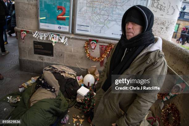 Michael stands amongst Christmas decorations he and his friend put up outside Green Park underground station on December 16, 2017 in London, England....