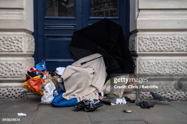 Homeless man sleeps in the door way of a theatre near Leicester Square on December 16, 2017 in London, England. Homeless charity Shelter have used...