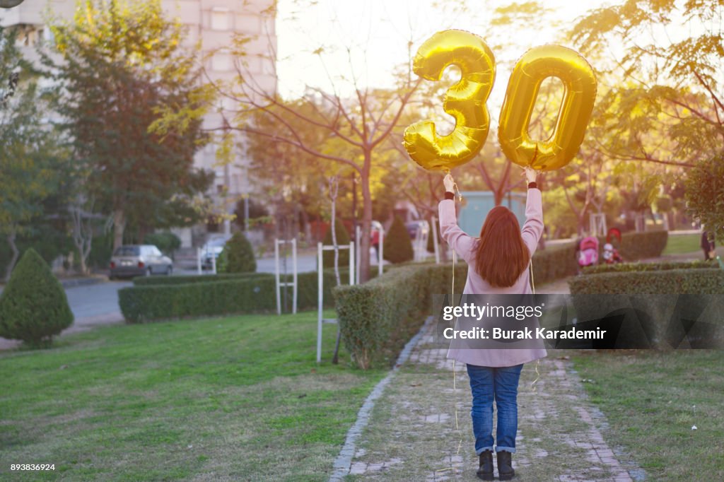 Young woman celebrates a thirty years birthday