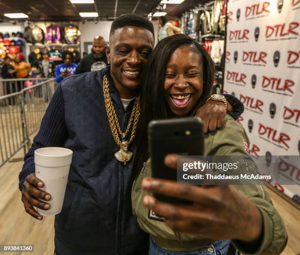 Lil Boosie poses with a fan for a selfi eat DTLR on December 15, 2017 in Atlanta, Georgia.