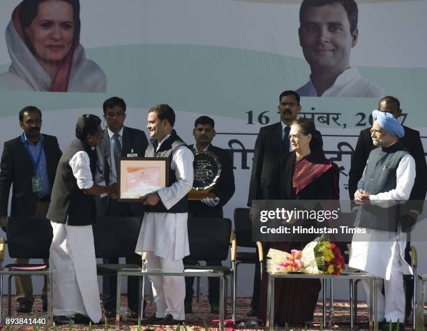 Congress central election authority chairman Mullappally Ramachandran hands over Rahul Gandhi the certificate of his elevation to the top post and...