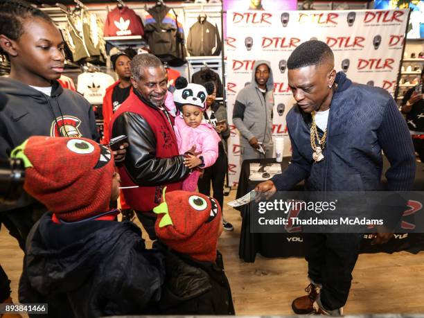 Lil Boosie gives the kids a 100 dollars at DTLR on December 15, 2017 in Atlanta, Georgia.