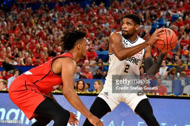 Perrin Buford of the Bullets looks to pass the ball against Jean-Pierre Tokoto of the Wildcats during the round 10 NBL match between the Perth...