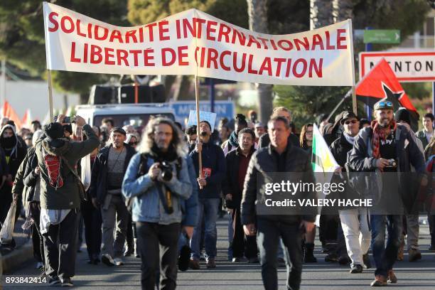 People and members of various associations including "Solidarite migrants-collectif 06", take part in a demonstration in support of migrants outside...