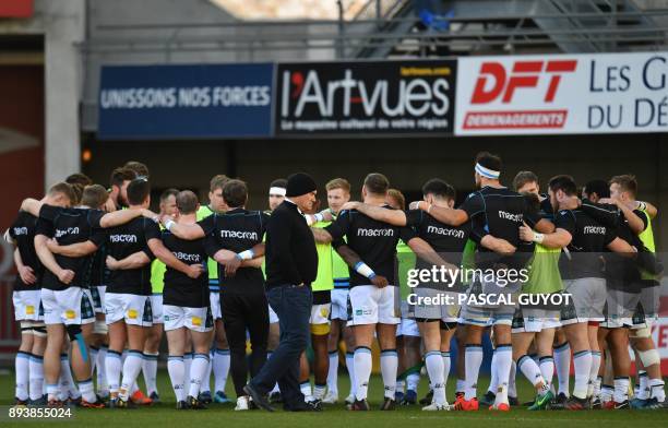 Glasgows's New Zealand head coach Dave Rennie passes as Glascow's players gather during the European rugby champions cup match between Montpellier...