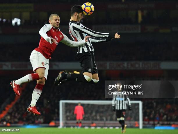 Newcastle United's Spanish midfielder Mikel Merino heads the ball under pressure from Arsenal's English midfielder Jack Wilshere during the English...