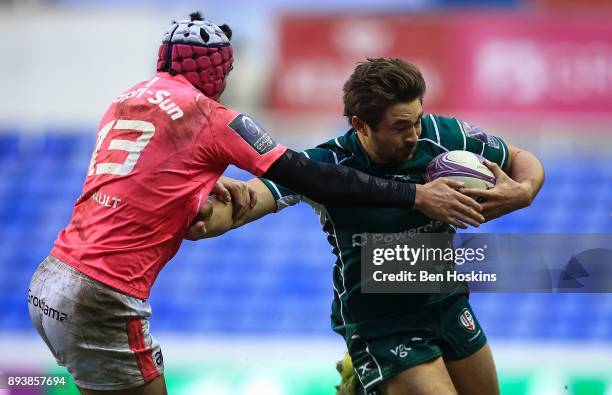Tom Fowlie of London Irish is tackled by Tho Millet of Stade Francais during the European Rugby Challenge Cup match between London Irish and Stade...