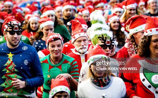 People take part in an Ugly Christmas Sweater Run on December 16, 2017 in The Vondelpark in Amsterdam. / AFP PHOTO / ANP / Koen van Weel /...