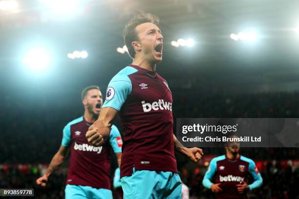 Mark Noble of West Ham United celebrates scoring the opening goal from the penalty spot during the Premier League match between Stoke City and West...