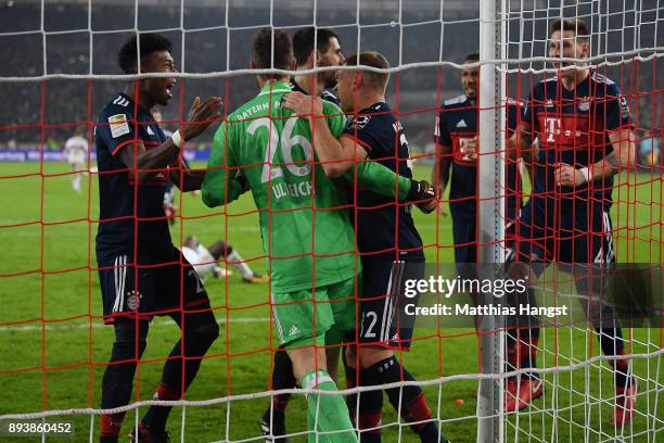 Sven Ulreich of Bayern Muenchen is congratulated by his team maes after he saved a penalty against Chadrac Akolo of Stuttgart during the Bundesliga...