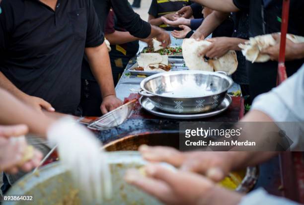 making traditional free street food distributed to people - refugee camp stock pictures, royalty-free photos & images
