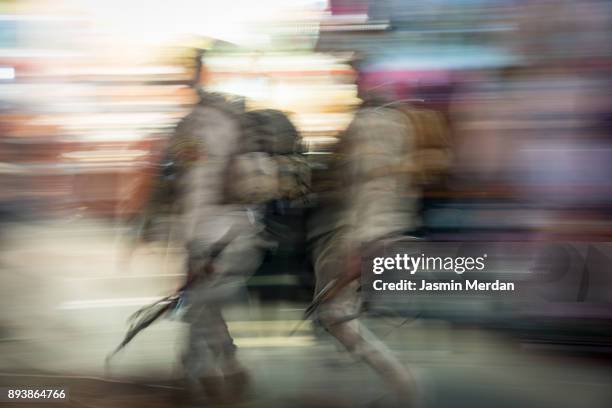 army soldiers walking between crowded people blurred motion walking - arbaeen stock pictures, royalty-free photos & images