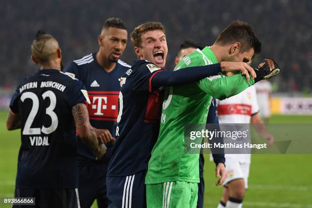 Sven Ulreich of Bayern Muenchen is congratulated by Thomas Mueller of Bayern Muenchen after he saved a penalty against Chadrac Akolo of Stuttgart...