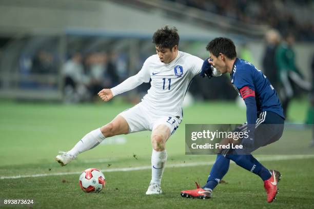 Gen of Japan and Lee Keunho of South Korea in action during the EAFF E-1 Men's Football Championship between Japan and South Korea at Ajinomoto...