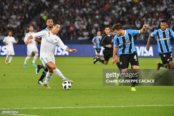 Real Madrid's Portuguese forward Ronaldo is marked by Gremio's Argentine defender Walter Kannemann during their FIFA Club World Cup 2017 final...