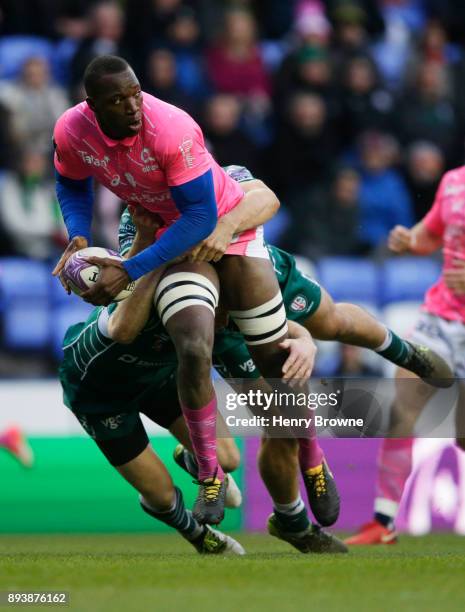 Sekou Macalou of Stade Francais is tackled by Tom Fowlie of London Irish and Greig Tonks of London Irish during the European Rugby Challenge Cup...