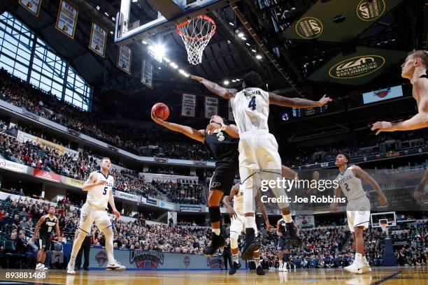 Carsen Edwards of the Purdue Boilermakers drives to the basket against Tyler Wideman of the Butler Bulldogs in the first half of the Crossroads...