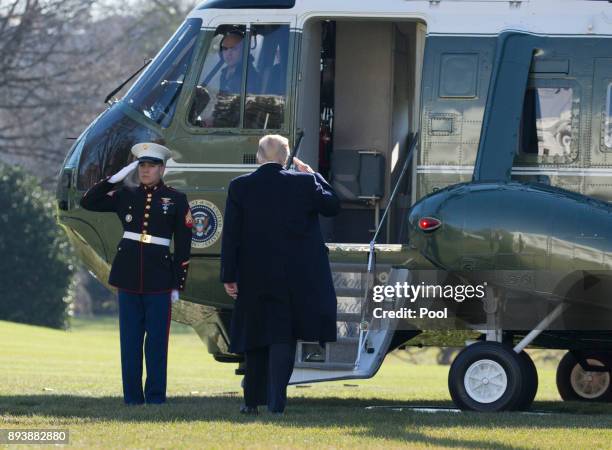 President Donald J. Trump salutes as he departs the White House December 16, 2017 in Washington, DC. Trump is heading for an overnight stay at Camp...