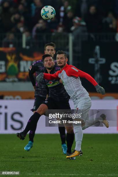 Marco Terrazzino of Freiburg and Marcel Heller of Augsburg battle for the ball during the Bundesliga match between FC Augsburg and Sport-Club...