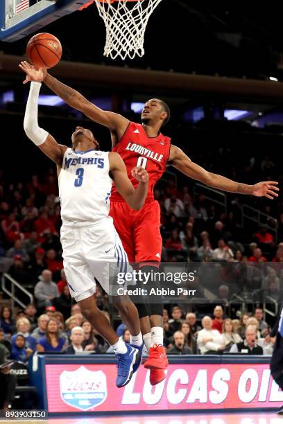 King of the Louisville Cardinals blocks a shot against Jeremiah Martin of the Memphis Tigers in the second half during their Gotham Classic game at...