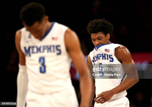 Jeremiah Martin and Kareem Brewton Jr. #5 of the Memphis Tigers react in the first half against the Louisville Cardinals during their Gotham Classic...