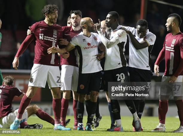 Amadou Bakayaoko of Walsall clashes with Matt Crooks of Northampton Town as his team mates Adam Chambers and Daniel Agyei attempt to restrain him...