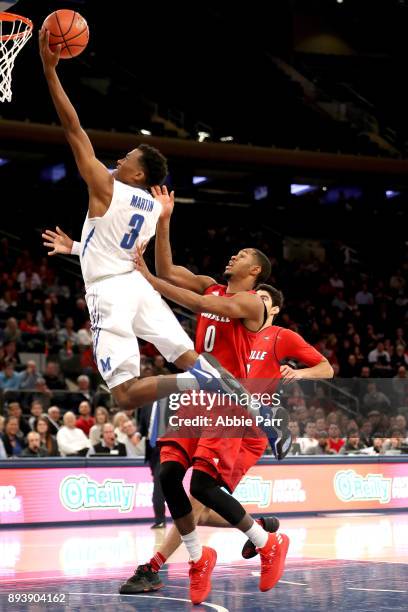 Jeremiah Martin of the Memphis Tigers takes a shot against V.J. King of the Louisville Cardinals in the second half during their Gotham Classic game...