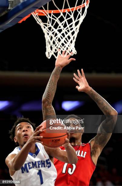 Jamal Johnson of the Memphis Tigers takes a shot against Ray Spalding of the Louisville Cardinals in the second half during their Gotham Classic game...