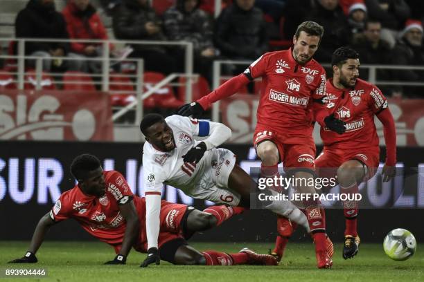 Lille's French defender Ibrahim Amadou is tackled by Dijon's Senegalese defender Hadji Papy Mison Djilobodji during the French L1 football match...