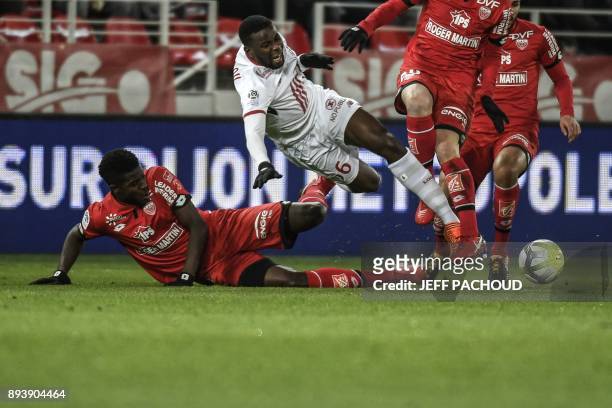 Lille's French defender Ibrahim Amadou is tackled by Dijon's Senegalese defender Hadji Papy Mison Djilobodji during the French L1 football match...