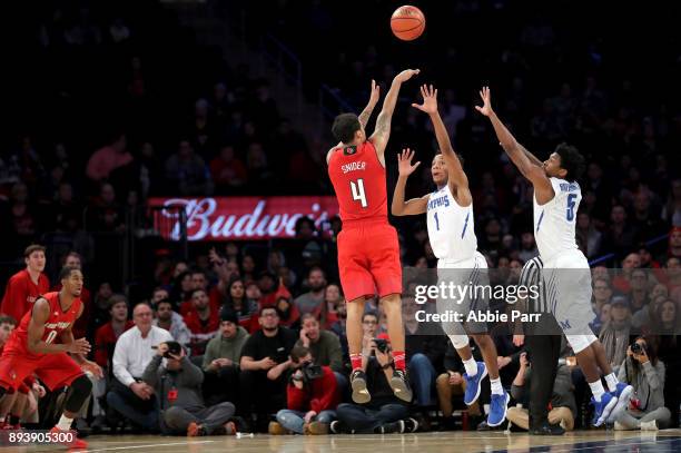 Quentin Snider of the Louisville Cardinals takes a shot against Jamal Johnson and Kareem Brewton Jr. #5 of the Memphis Tigers in the second half...