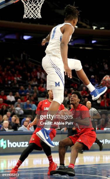 Kyvon Davenport of the Memphis Tigers goes to block a shot by Darius Perry of the Louisville Cardinals in the second half during their Gotham Classic...