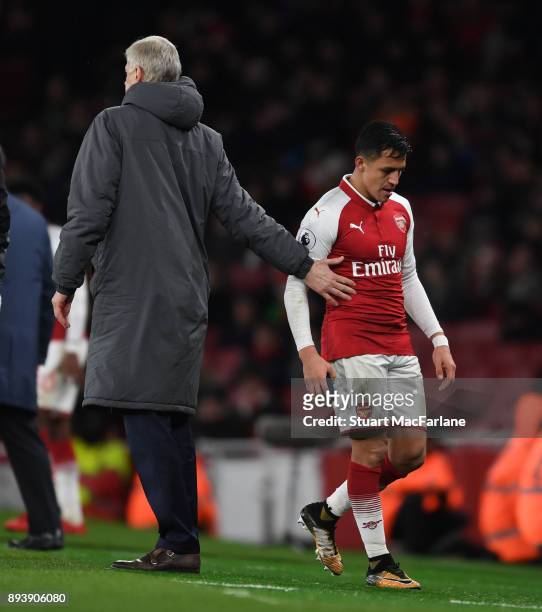 Alexis Sanchez with Arsenal manager Arsene Wenger after his substitution during the Premier League match between Arsenal and Newcastle United at...