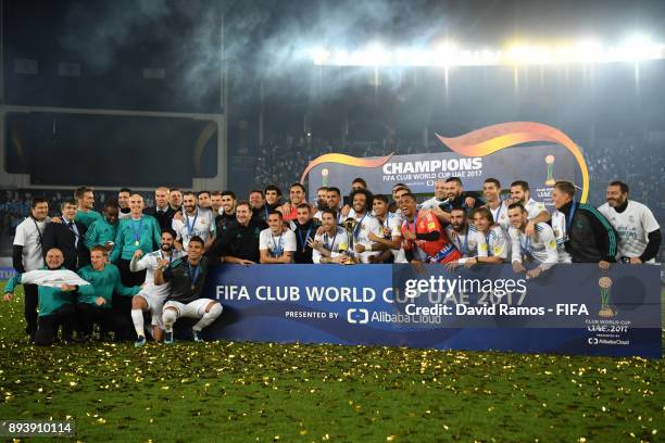 The Real Madrid team pose for a team photo with the trophy after the FIFA Club World Cup UAE 2017 Final between Gremio and Real Madrid at the Zayed...