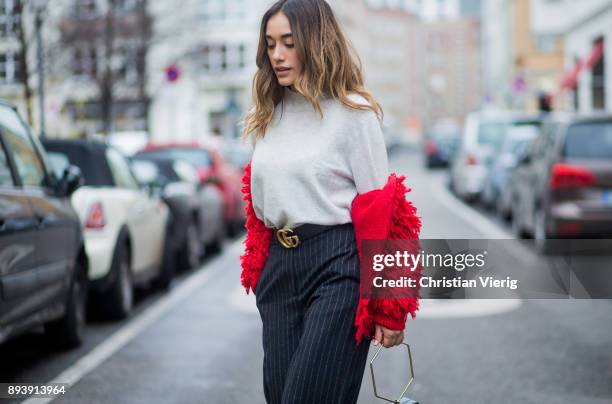 Anna Sharypova wearing Gucci belt, grey H&M turtleneck, red jacket &other stories, navy striped H&M pants, Zara bag, Buffalo heels on December 16,...