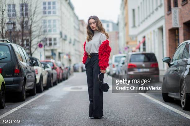 Anna Sharypova wearing Gucci belt, grey H&M turtleneck, red jacket &other stories, navy striped H&M pants, Zara bag, Buffalo heels on December 16,...