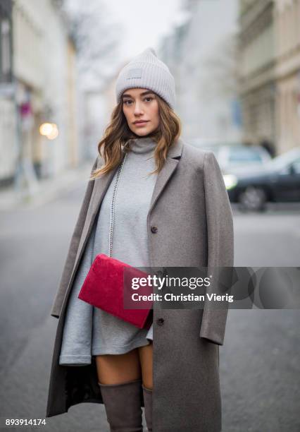 Anna Sharypova wearing Stuart Weitzman overknee boots, a grey COS coat, red Agneel bag, grey COS turtleneck on December 16, 2017 in Berlin, Germany.