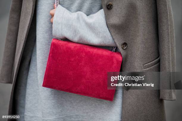 Anna Sharypova wearing Stuart Weitzman overknee boots, a grey COS coat, red Agneel bag, grey COS turtleneck on December 16, 2017 in Berlin, Germany.