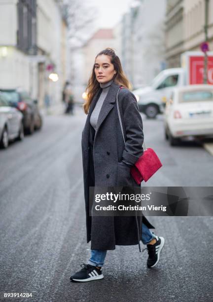 Anna Sharypova wearing red Agneel bag, dark grey COS wool coat, Adidas sneaker, boyfriend denim jeans &other stories, top Uniqlo, on December 16,...