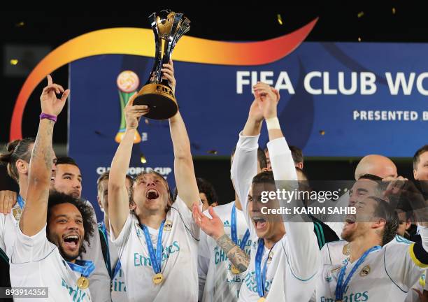 Real Madrid's Marcelo, Luka Modric, Cristiano Ronaldo and Sergio Ramos celebrate with the FIFA Club World Cup trophy following their victory in the...