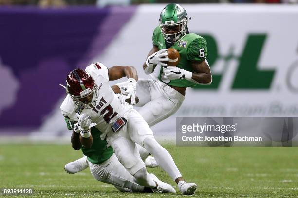 Kishawn McClain of the North Texas Mean Green intercepts a pass intended for John Johnson of the Troy Trojans in the first half during the R+L...