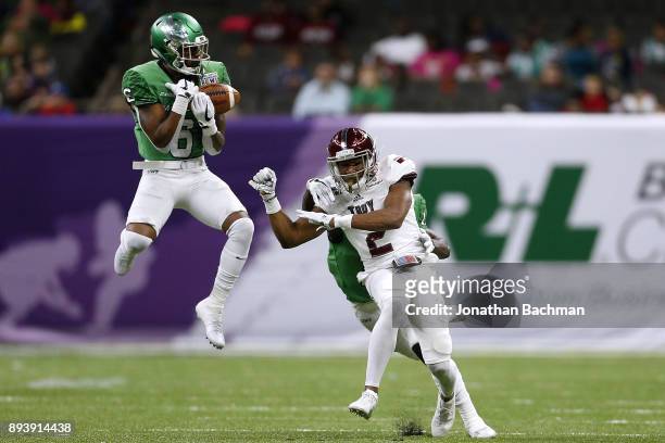 Kishawn McClain of the North Texas Mean Green intercepts a pass intended for John Johnson of the Troy Trojans in the first half during the R+L...